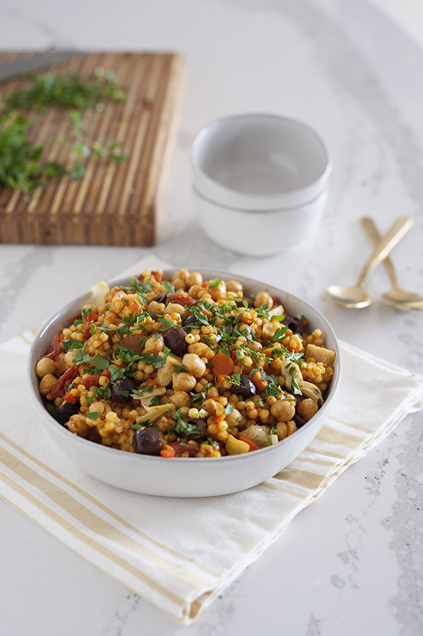 This delicious One-Pot Sicilian Couscous dish from One-Dish Vegan is made with Israeli couscous, chickpeas, olives, and an assortment of vegetables.